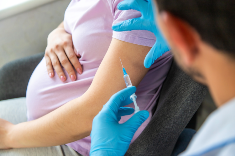 A pregnant woman makes a vaccination. Selective focus. doctor.