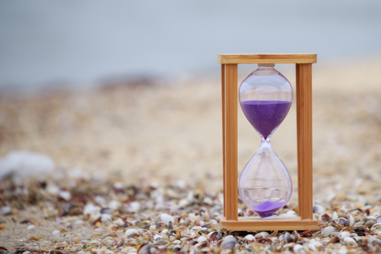 Close-up photo of wooden hourglass at the beach. High quality photo